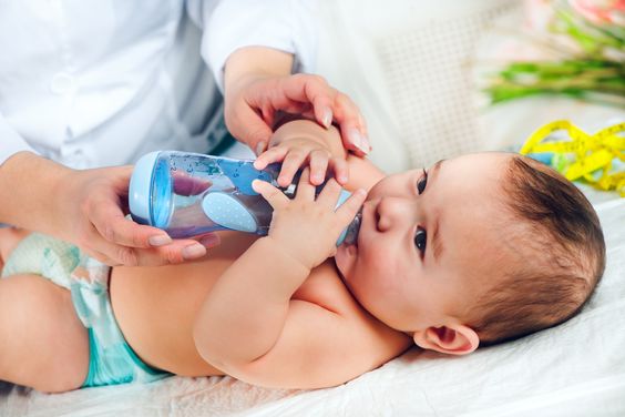 A baby is being feeding water A baby is being feeding water
