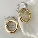Silver round hoop earring with gold round pendant