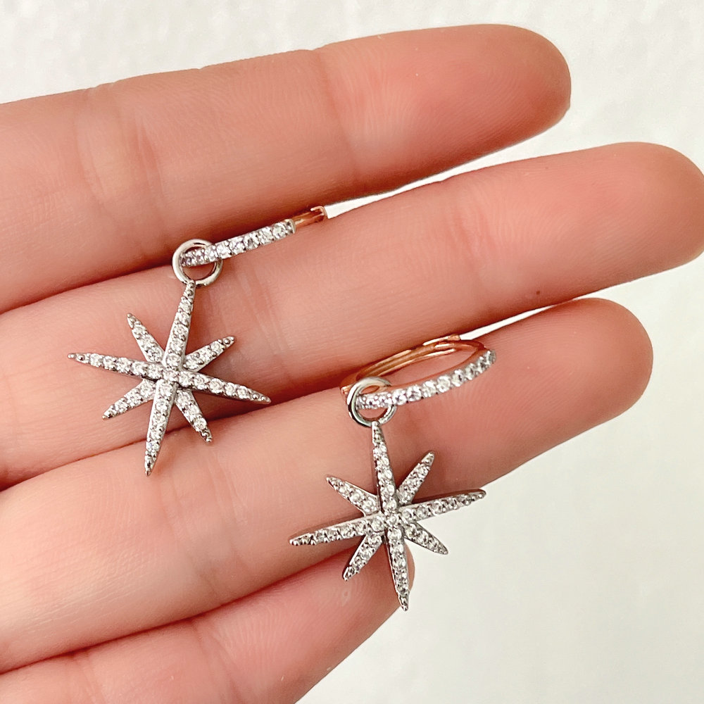 Gold hoop earring with silver star charm