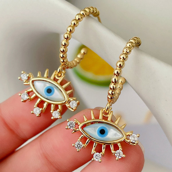 Gold beaded hoop earrings with eye charm