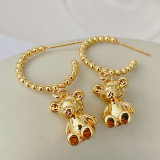 Gold beaded hoop earring with Bear charm