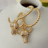 Gold beaded hoop earring with Horn charm
