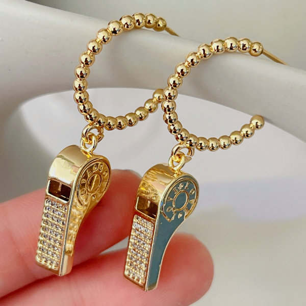 Gold beaded hoop earring with whistle charm