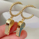 Gold beaded hoop earring with whistle charm