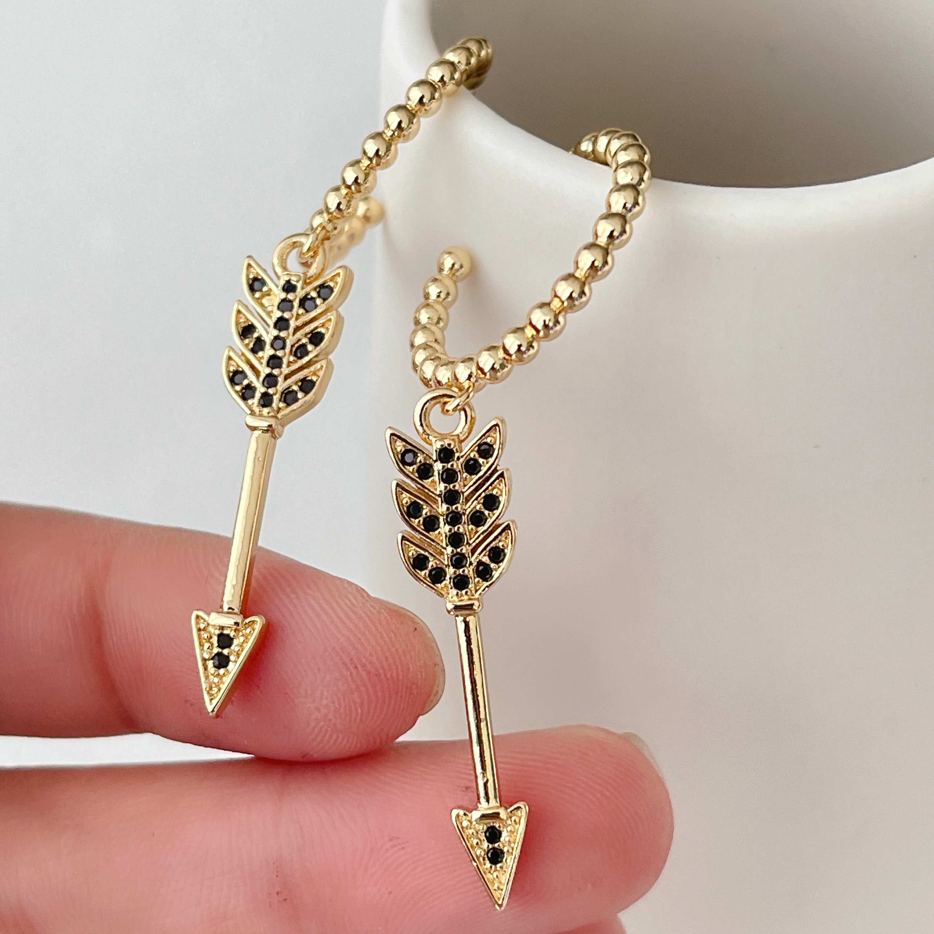 Pave gold beaded hoops earrings with arrow charm