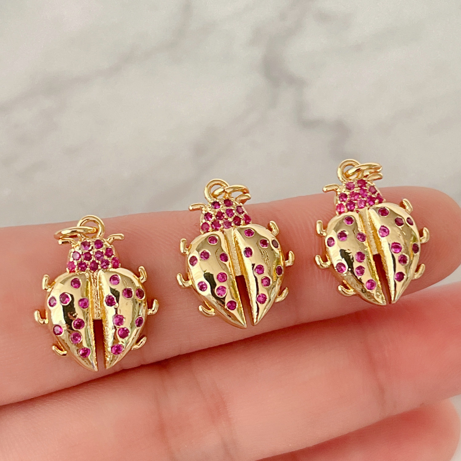 Red zircon ladybug charm