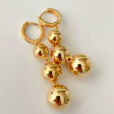 Three gold ball earrings