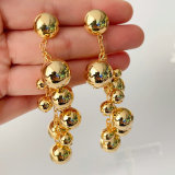 Long gold ball earrings