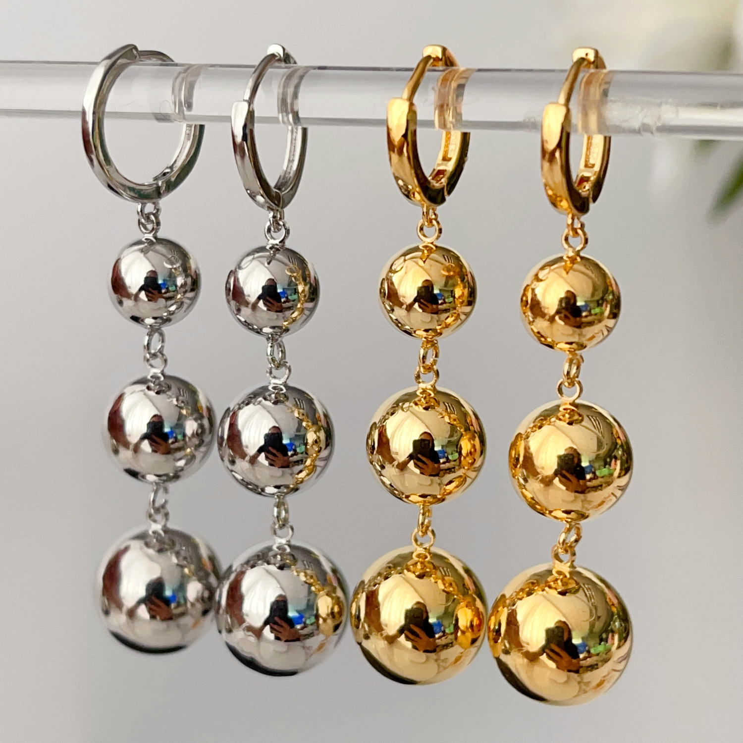 Three gold ball earrings