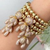 Gold bead bracelet with big cz bear in pink