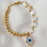 Half gold ball half pearl bracelet with mop evil charm
