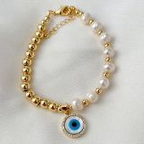 Half gold ball half pearl bracelet with mop evil charm