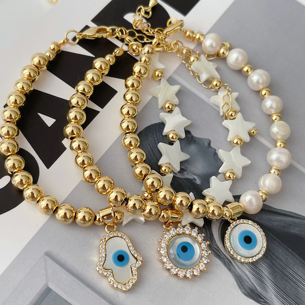 Half gold ball half pearl bracelet with mop evil charm