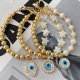Half gold ball half pearl bracelet with mop evil charm