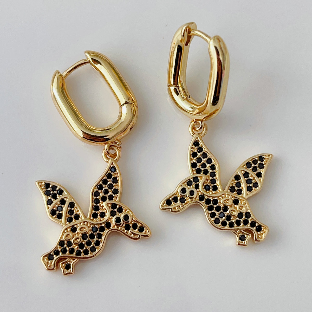Black dinosaur drop earrings