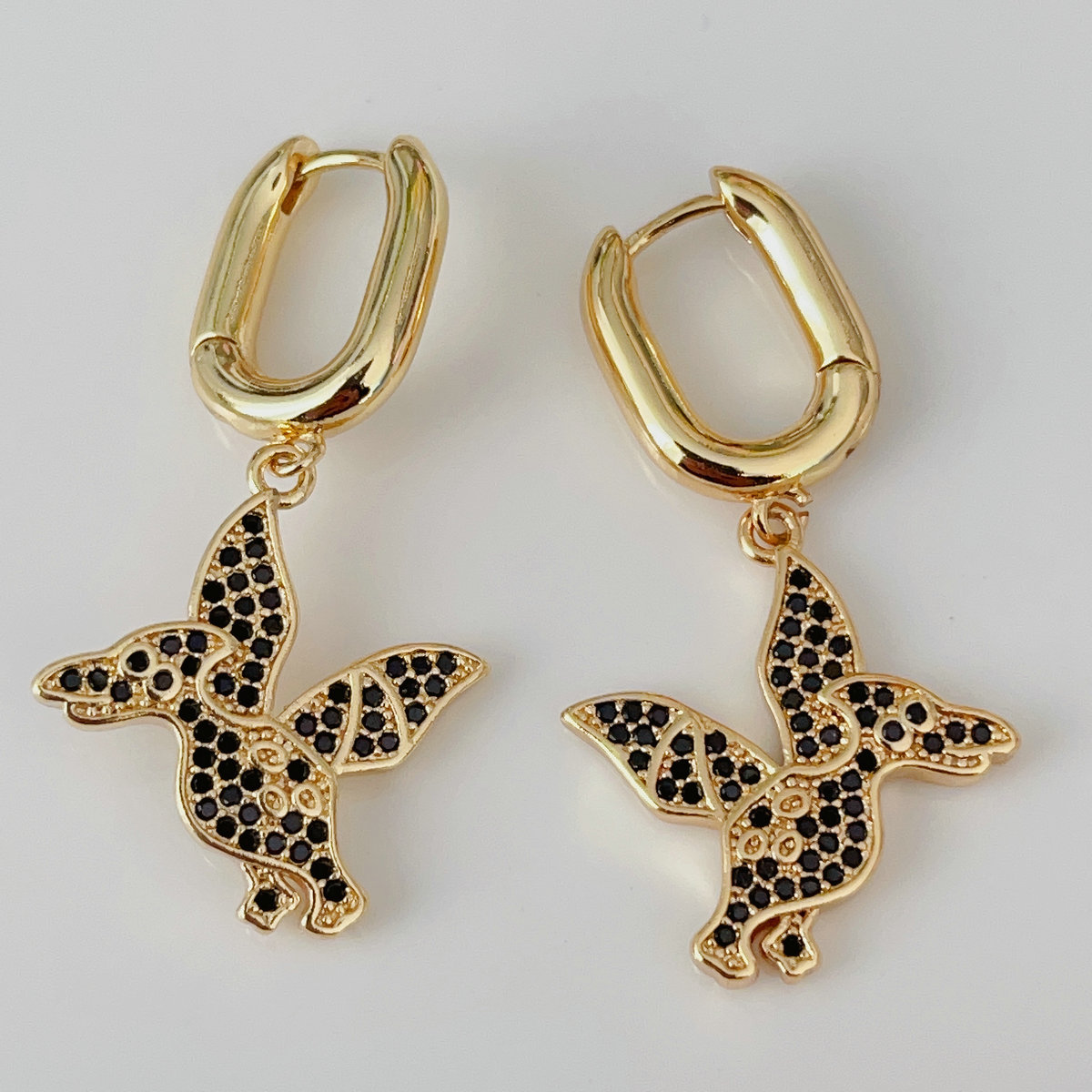 Black dinosaur drop earrings