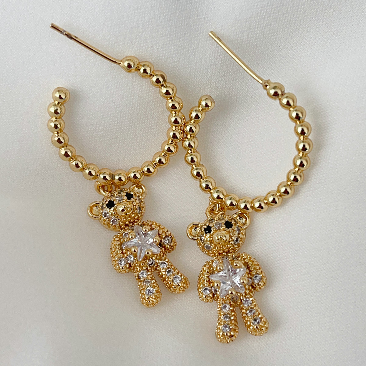 Gold bead hoops with bear pendant