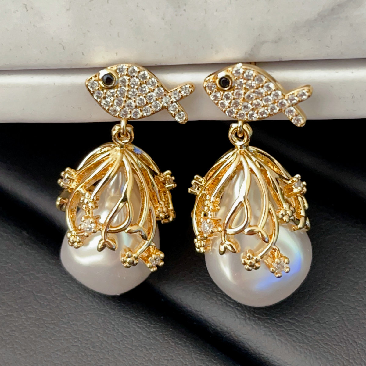 Pave fish earring with glass pearl pendant