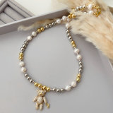 Gold bead necklace with teddy bear pendant