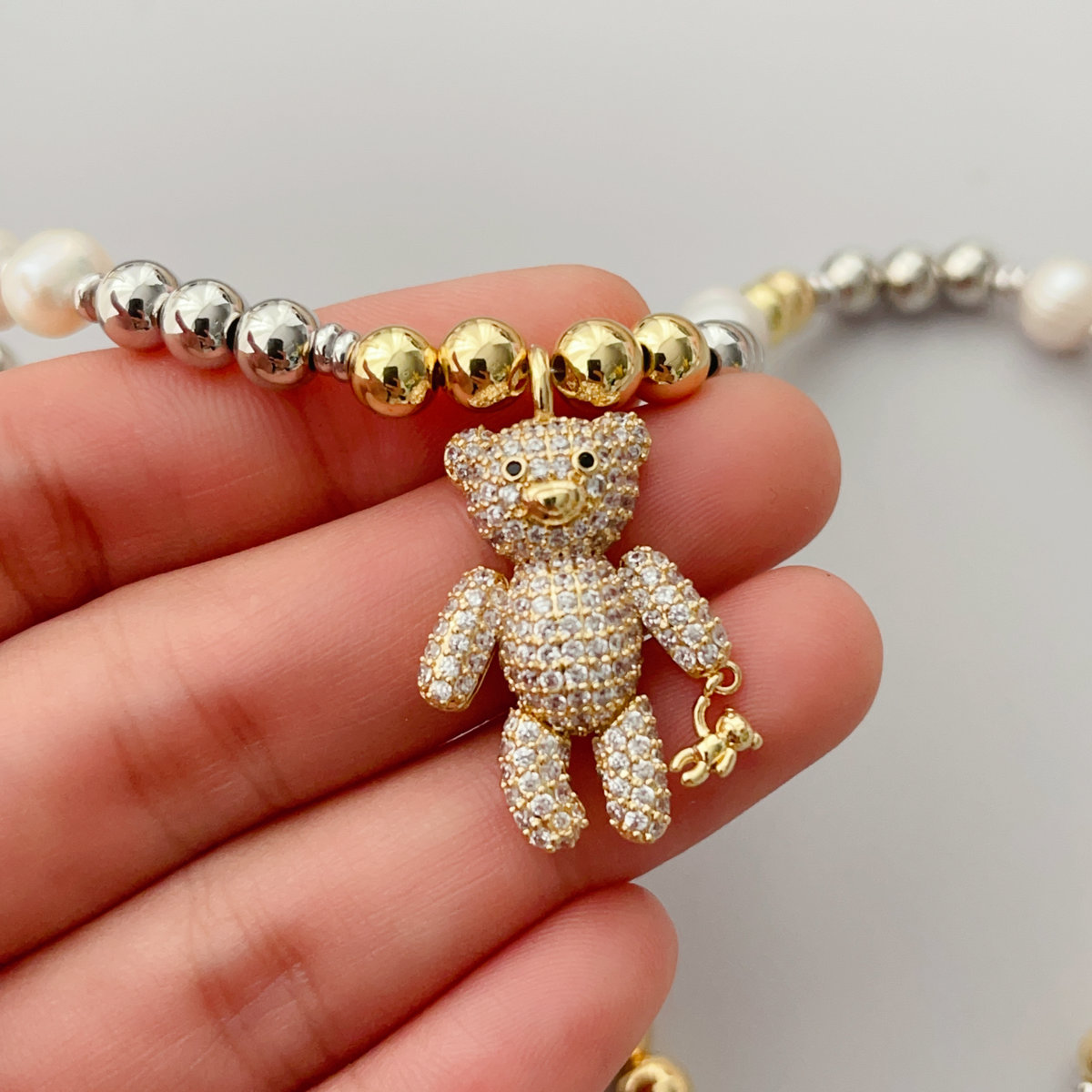 Gold bead necklace with teddy bear pendant