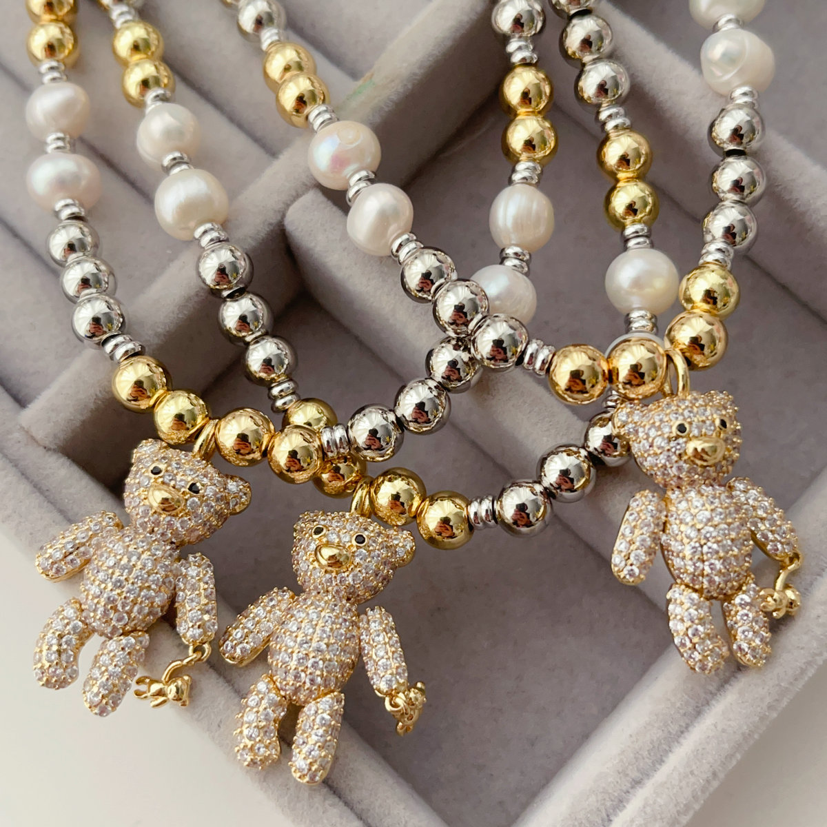 Gold bead necklace with teddy bear pendant