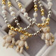 Gold bead necklace with teddy bear pendant