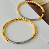 Silver and gold color twist bangle