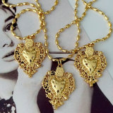 Oval gold bead necklace with heart charm