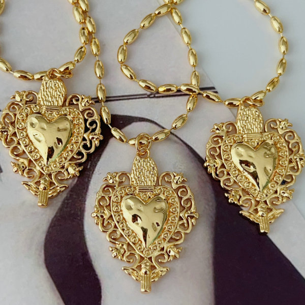 Oval gold bead necklace with heart charm