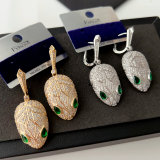 Pave green eye snake earrings