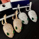 Pave green eye snake earrings
