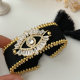 Black cord bracelet with eye charm