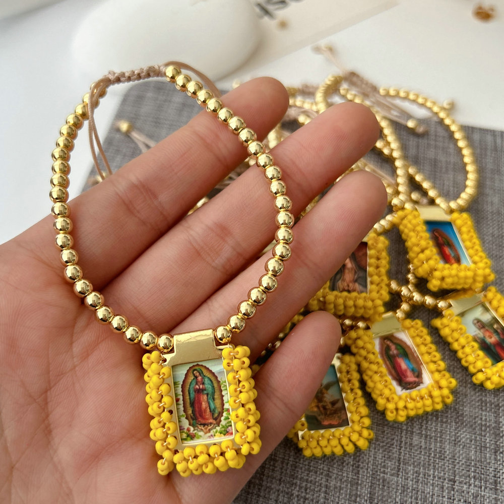 Handmade yellow bead religious pendant bracelet