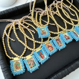 Handmade blue bead religious pendant bracelet