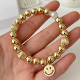 Gold ball bracelet with smile charm