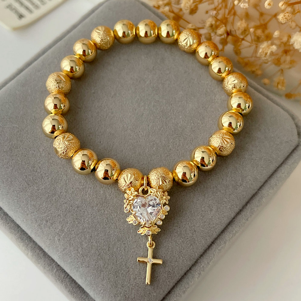 Gold ball bracelet with heart charm