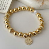 Gold ball bracelet with smile charm