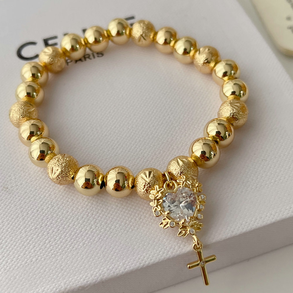 Gold ball bracelet with heart charm