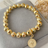 Gold ball bracelet with coin charm