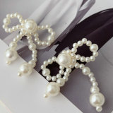 Glass pearl bow earrings