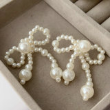 Glass pearl bow earrings
