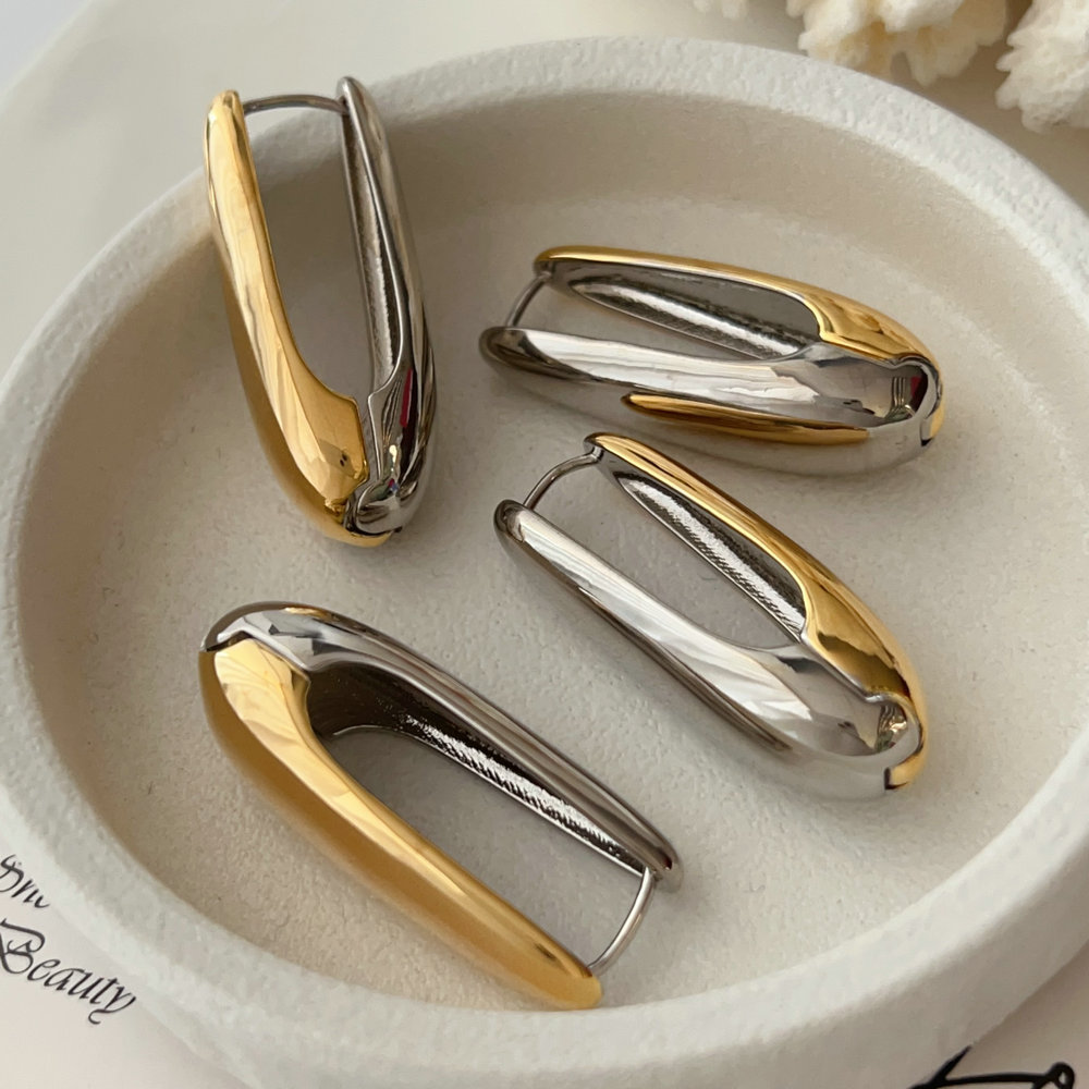Silver and gold metal oval earrings