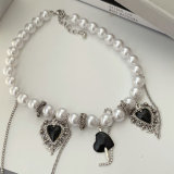 Glass pearl necklace with enamel heart charm