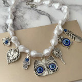 Glass pearl necklace with eye charm