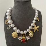 Glass pearl bee charm necklace