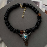 Black bead necklace with horn pendant