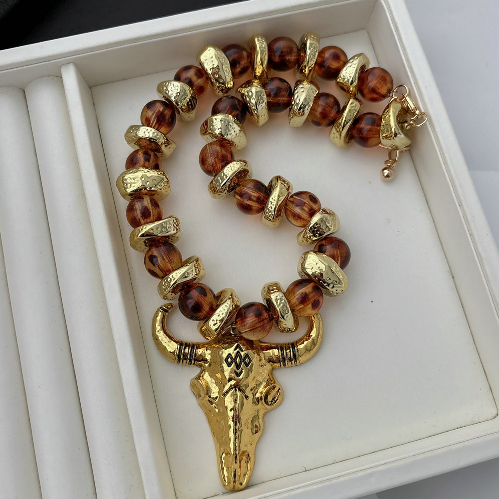 Acrylic necklace with horn pendant