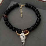 Black bead necklace with horn pendant