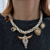 White cord necklace with horn charm