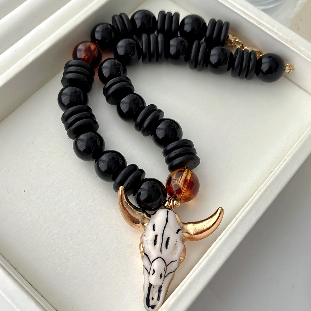 Black bead necklace with horn pendant
